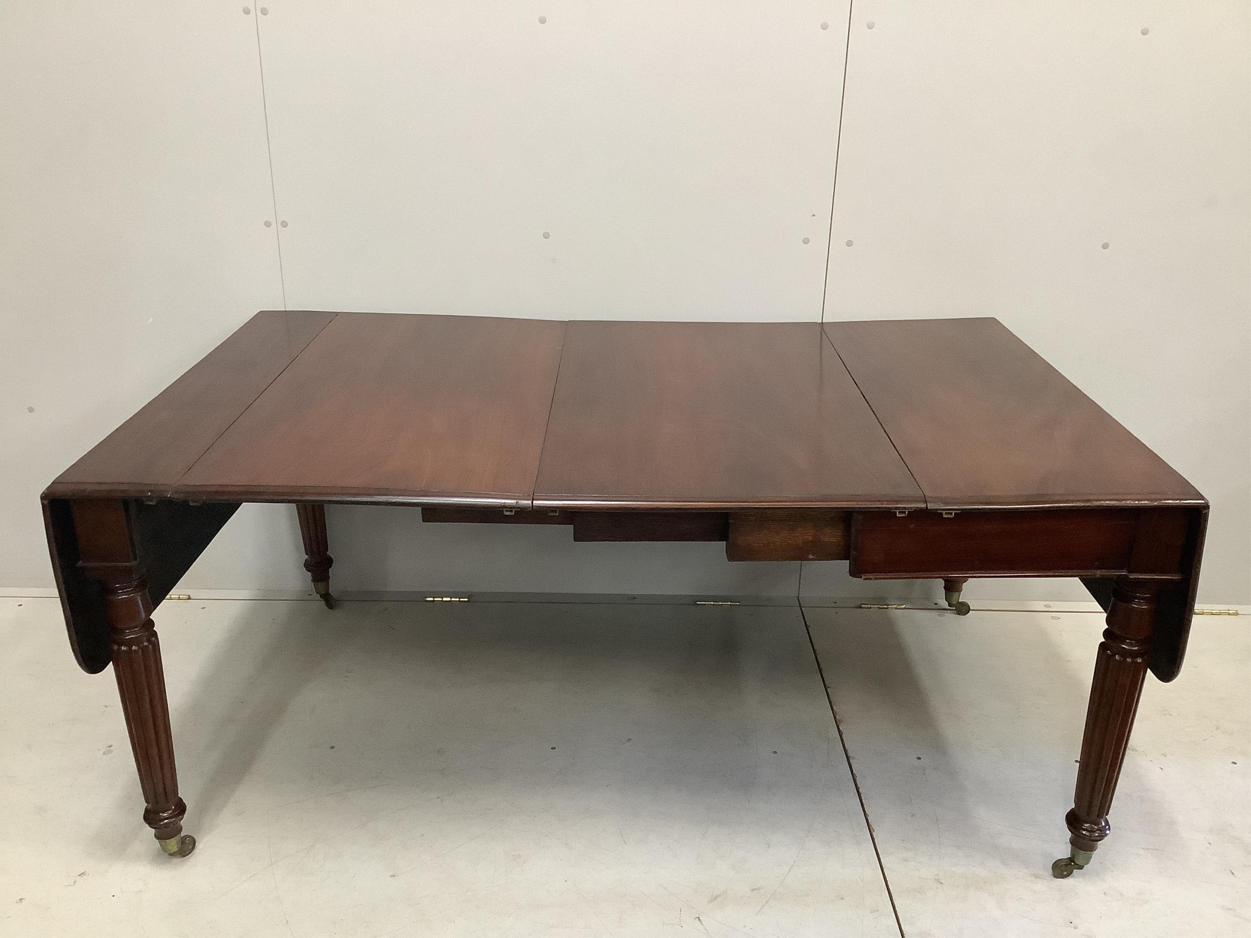 A George IV mahogany drop flap extending dining table, width 228cm extended, two spare leaves, depth 102cm, height 73cm